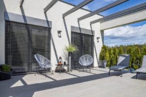 Zip track blinds lowered on an outdoor terrace